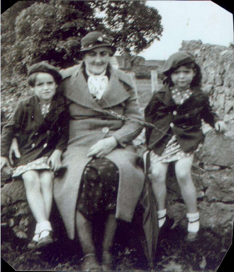 Sister Sheelagh, Grandma, Mrs. Dyer sitting on the wall outside the house in 1938