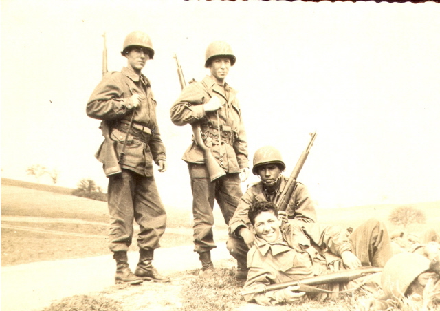 Jose Maria Ayala squatting with fellow Army soldiers in Basic Training