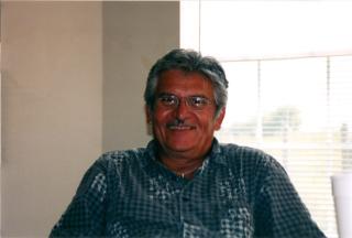Teofilo sitting with family at current residence in 1998.