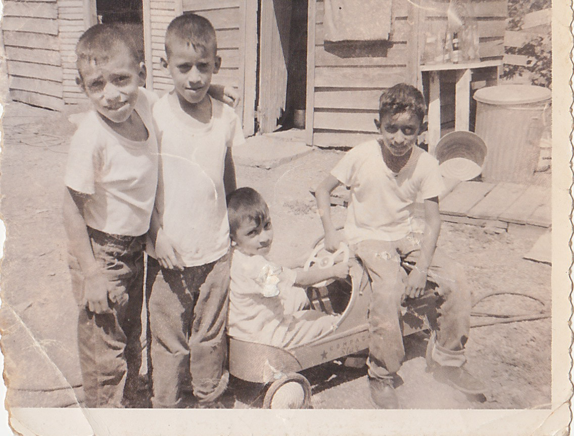 Daniel, John, Raul, and Fred in front of there home