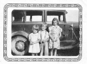 my aunt marjean growing up as the youngest of three standing in front of the family car