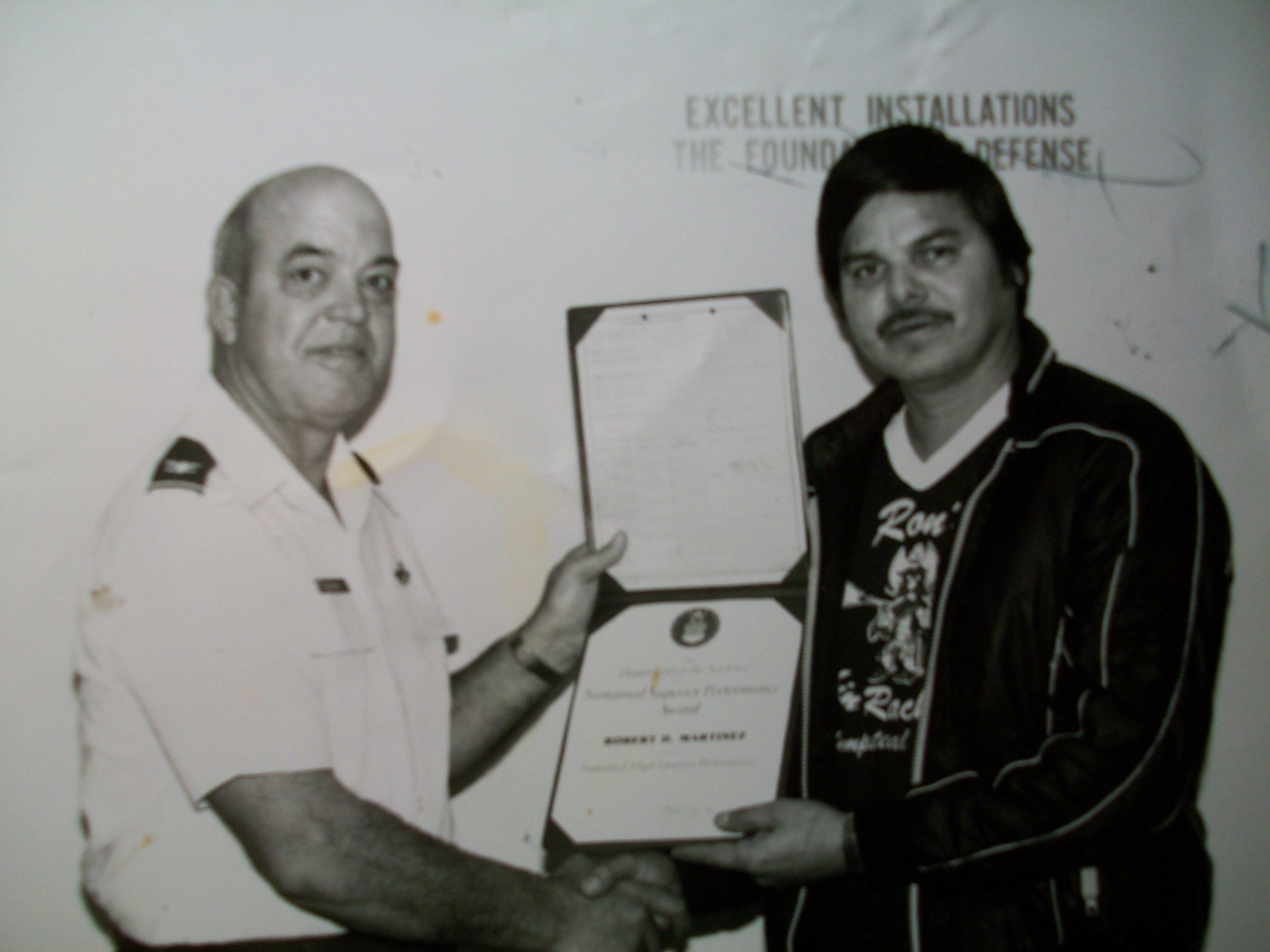 Robert Martinez accepting an award for his excellence of performance in his duties at Kelly Airforce base.