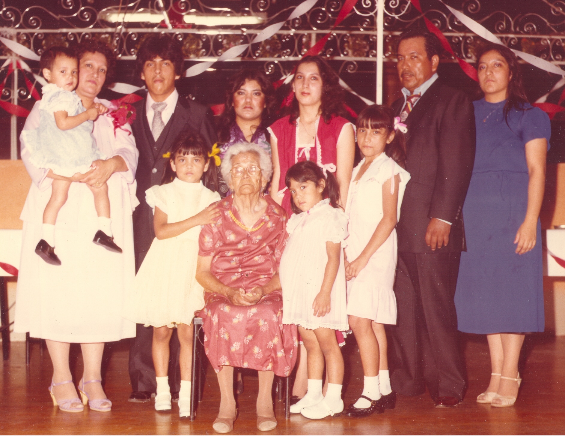 Juanita Araiza,Fernando, Maria,Amelia, Andrez, Particia, Leticia ,Christina, Alicia , Monica, Gregoria (99 Years Old) at a graduation at Skylite Ballroom at Zarzamora Street in 1987.