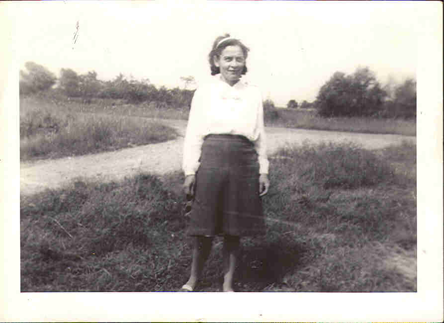 Audie's mother, Agnes, age 40 at the end of the driveway.