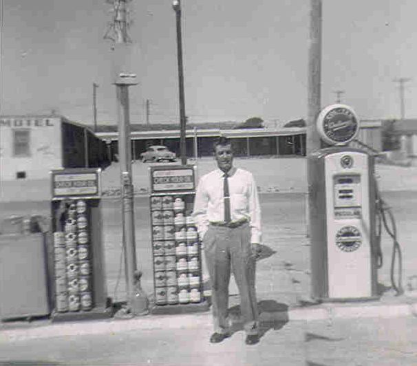 Audie's uncle, William Belrose, standing by an old gas pump.
