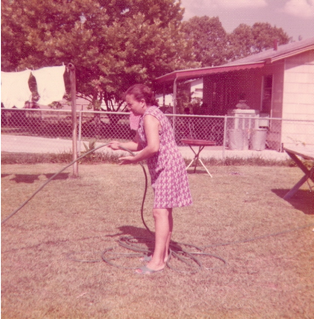 Amalia watering the yard in 1975