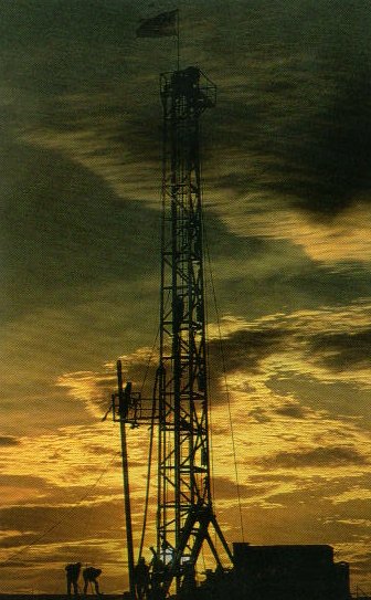 Oil well at sunset