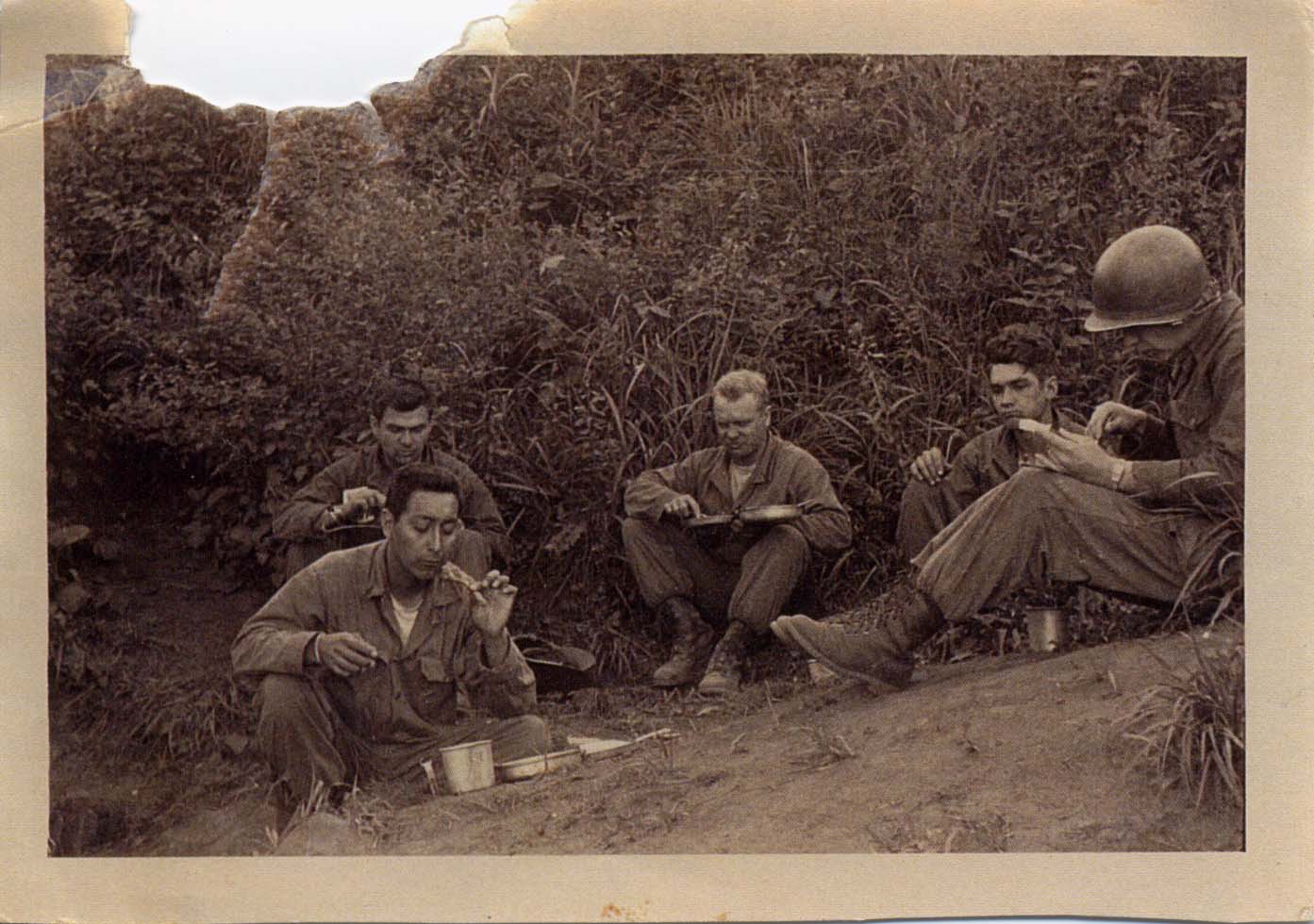 Trinidad in front left eating with his company