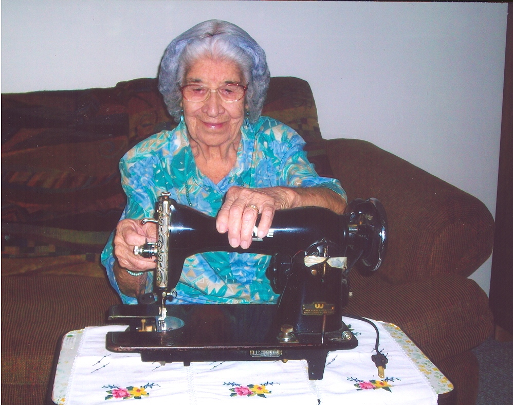Here Tia Pete is sitting down with her sewing manchine that is over 100 years old, and to this day it is still working.She is in her living room on October the 16 of 2010 around 2 o'clock pm on a Sunday afternoon.></a>

<a href=