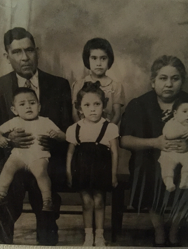 Olivia Vasquez (top middle) with foster family