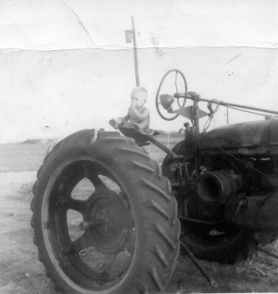 Carl Santleben 1yrs old climbed up on
the tractor by himself and started sucking his thumb.