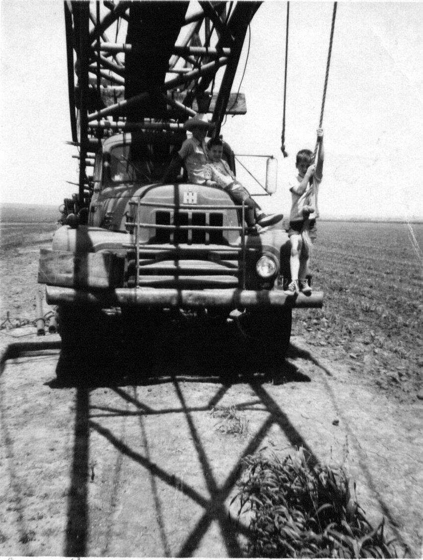 Carl and George swinging on the rope, drilled the irrigation well 200 yards south of Highway90 in March 1965