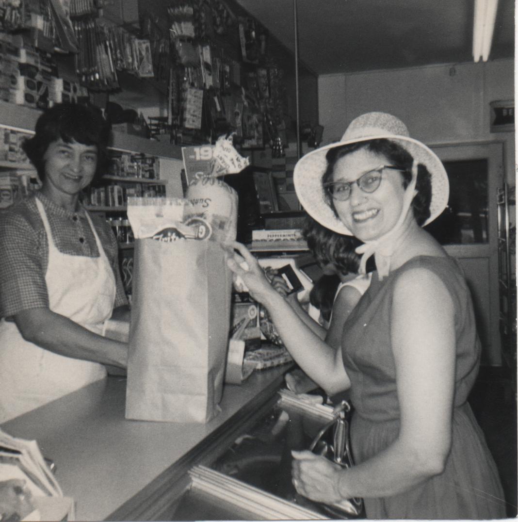 Mary Syma at the store stocking up for a road trip to the coast.  1952