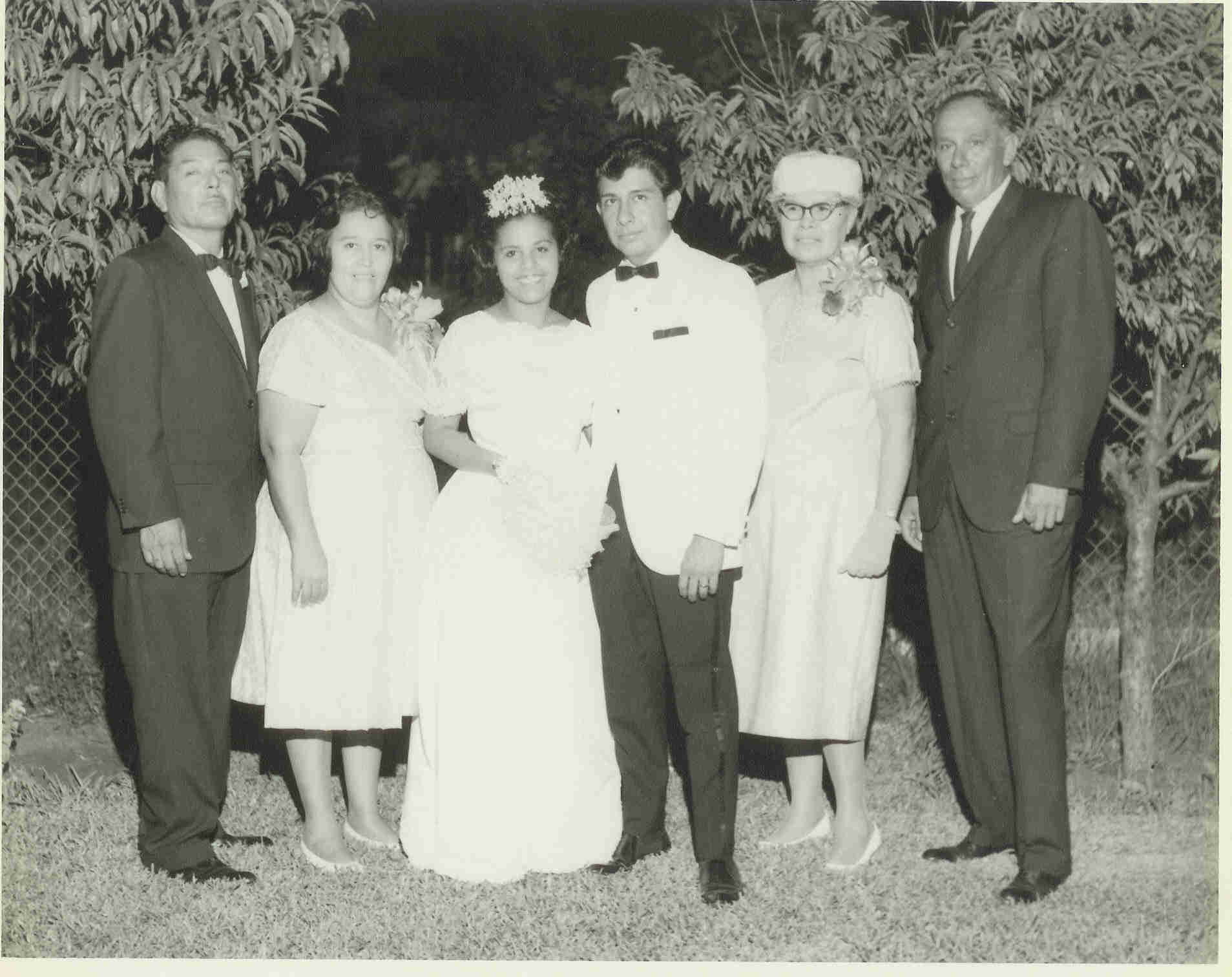 Yolanda and Marconi standing with their parents