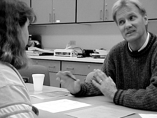 History Professor Peter Myers talks with Education major Sharon Lowman
