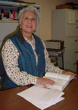 Maria Antonieta Galvan, association professor of Spanish, looks through a book in the Foreign Language Lab in the GE Building. Photo by Suzann Torres