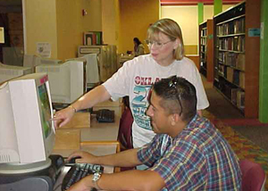 Sandi Hood, coordinator of Library Automative and Access Services, assists a student in the Ozuna Learning Resources Center. Photo by Michelle Tyler