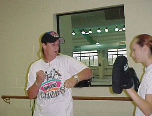 Tracey Sullivan warms up before starting her kickboxing class. Photo by Michelle Tyler