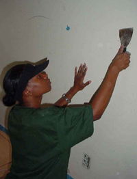Palo Alto student T'Andra Smith helps the Catholic Campus Ministry restore an elderly couple's home. Photo by Suzann Torres