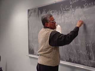 Dr. Castillo works a math problem for his students
