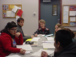 Dr. Richter listens intently to one of her students.
