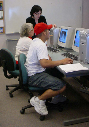 Photo of Professor Camero works with her Digital Arts students