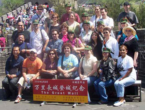 Students and faculty pose for a picture in front of the Great Wall of China.