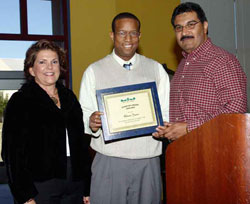 Starfish recipient Oliver Jones is congratulated by President Guzman and Dr. Dan Rodriguez