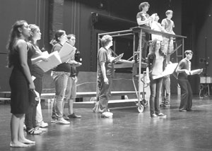 Cast members work hard during rehearsal. Photo by Maria Gutierrez